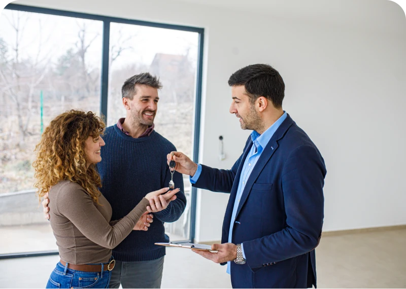 Couple receiving house keys from agent